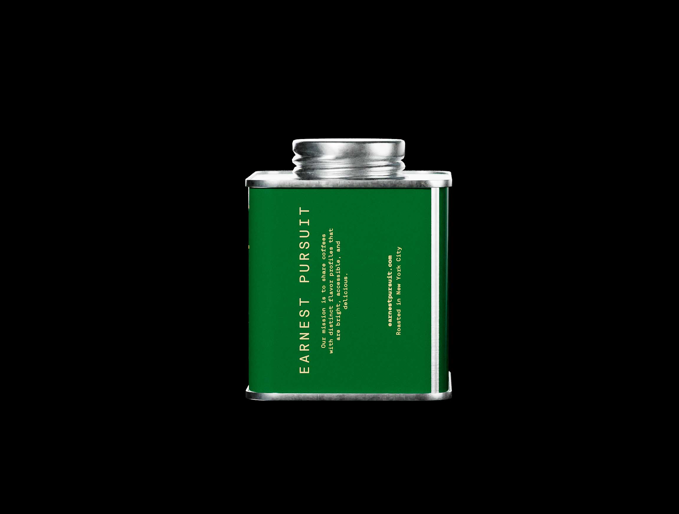 Side view of the green Earnest Pursuit tin showing vertical typography reading the brand name in muted gold, aligned along the edge of the matte label. Additional product information and roasting location are set in compact, legible type, carefully spaced to maintain hierarchy. The metallic frame and lid catch soft highlights from studio lighting, emphasizing material contrast. The composition showcases deliberate creative direction and refined packaging design, where typography placement becomes a defining structural element of the identity system.