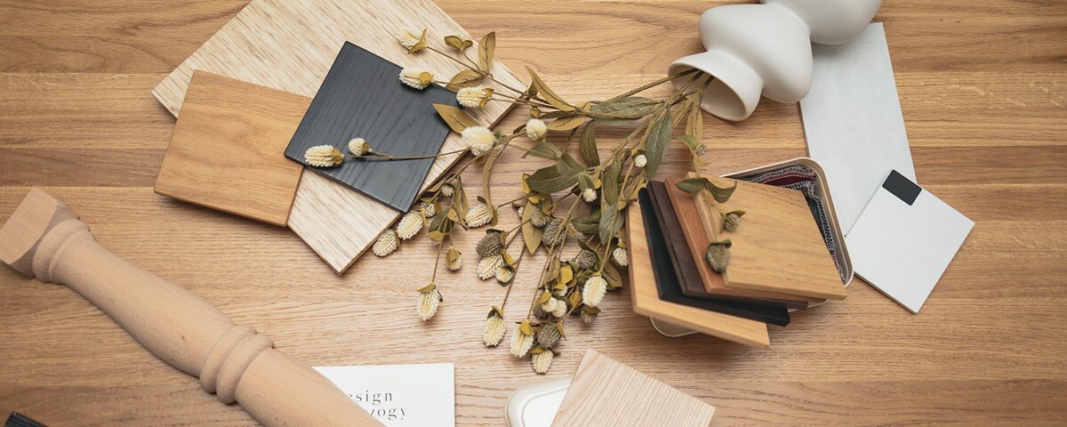 Wood samples, material swatches, and design elements on a wooden surface – inspiration for custom furniture by Furnilo