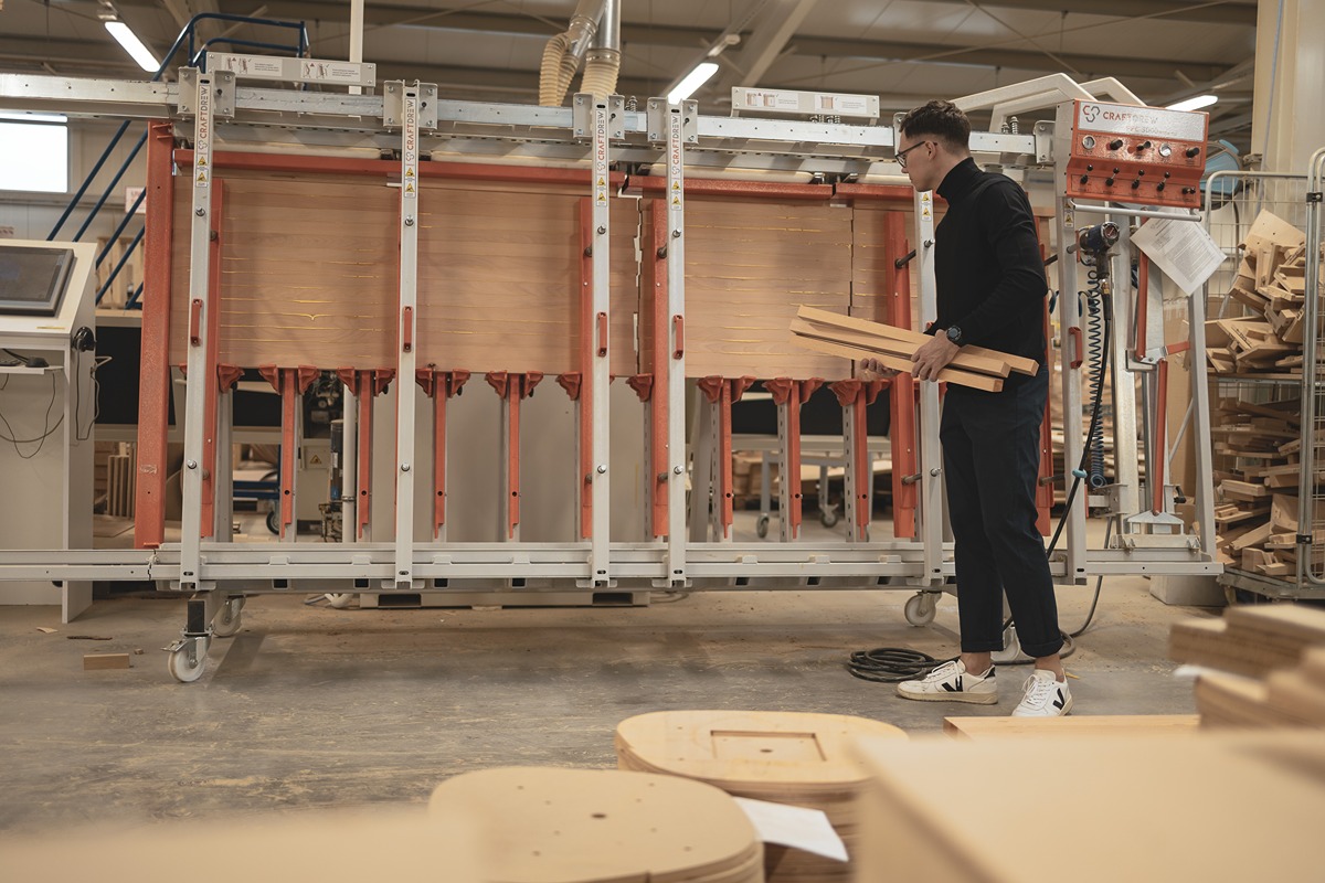 Manual wood selection process in carpentry workshop – ensuring quality and consistency
