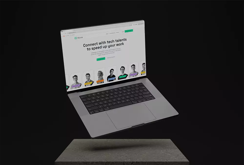 En svävande Macbook över ett betongblock.