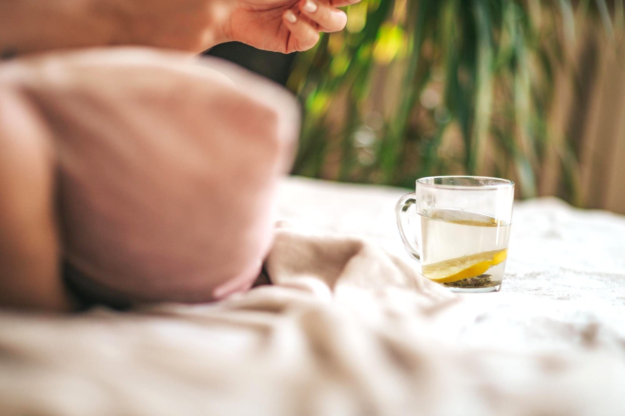 Hands using a mortar and pestle to prepare natural botanical medicine, representing holistic and natural treatments at Botaniqal Clinic