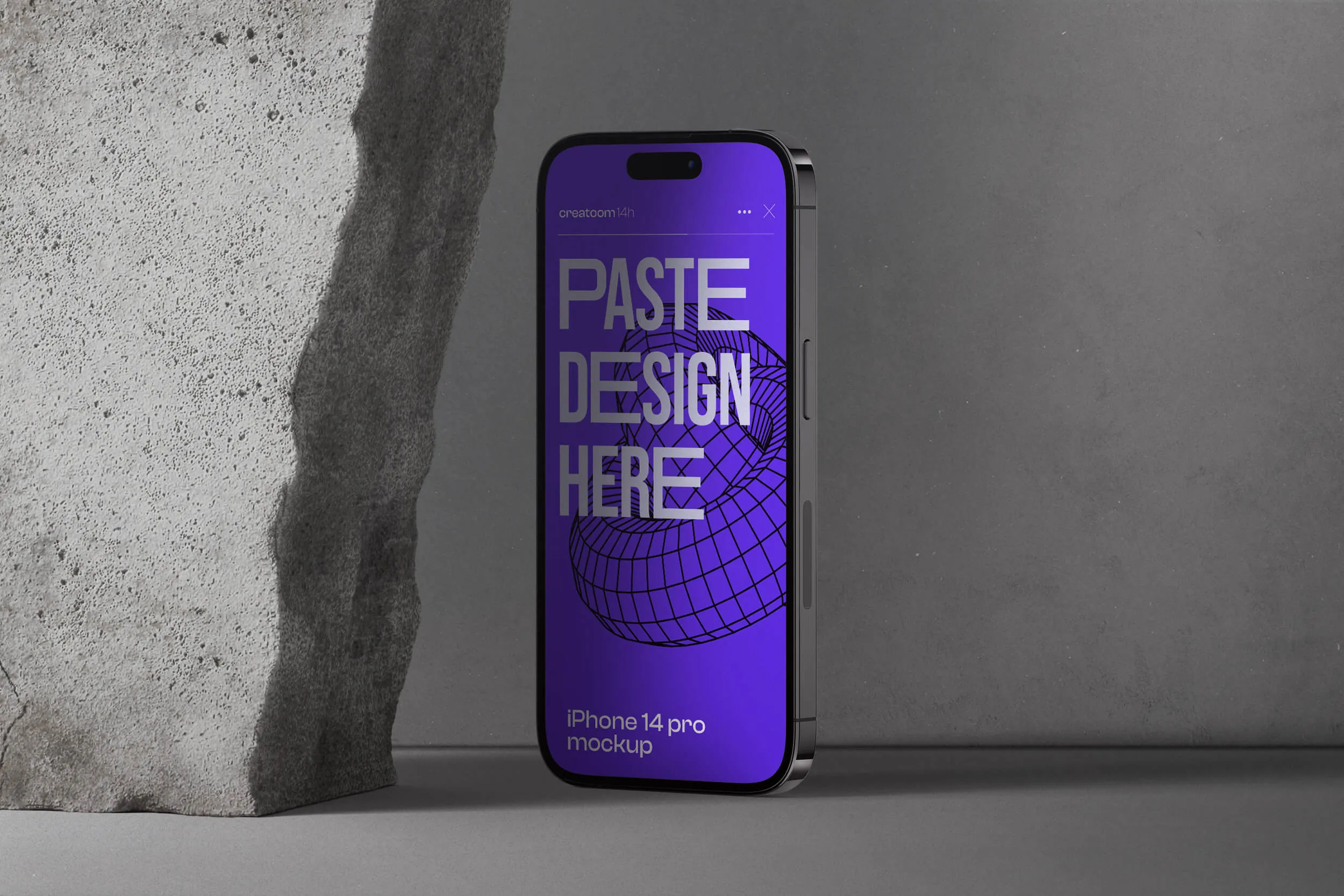 A phone next to a stone.