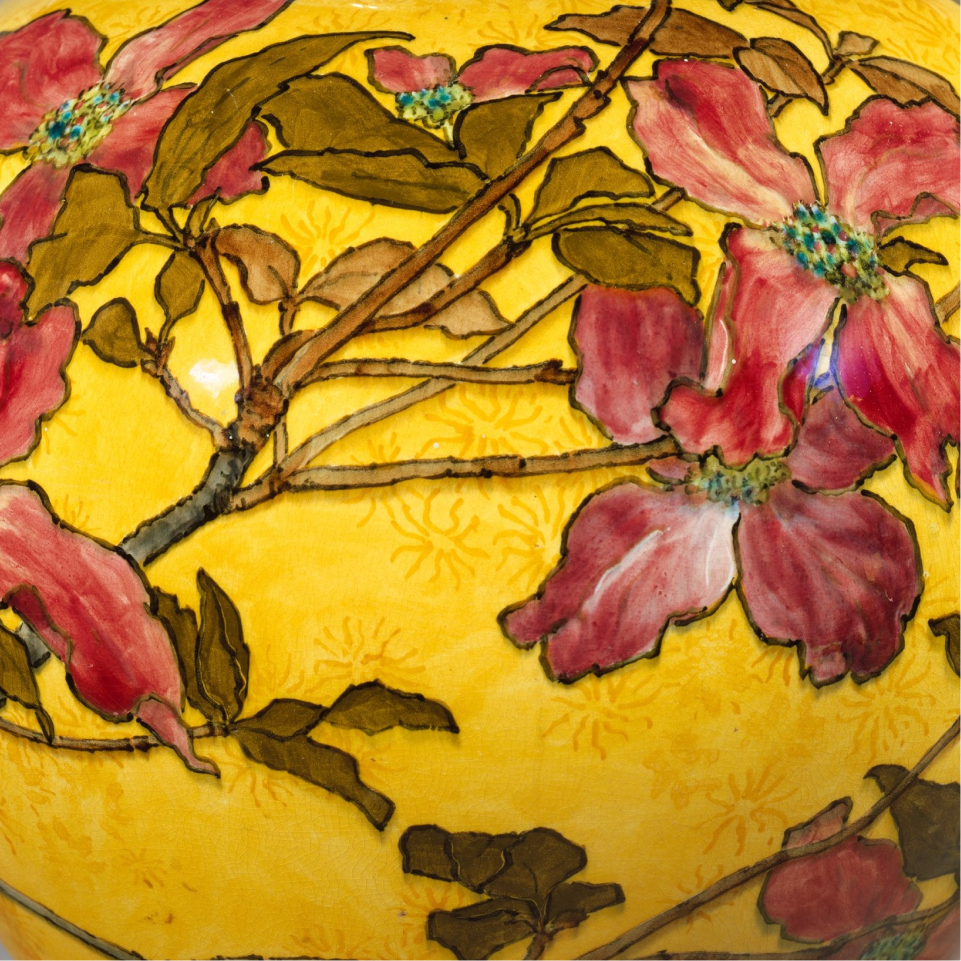 yellow vase with red dogwood blossoms