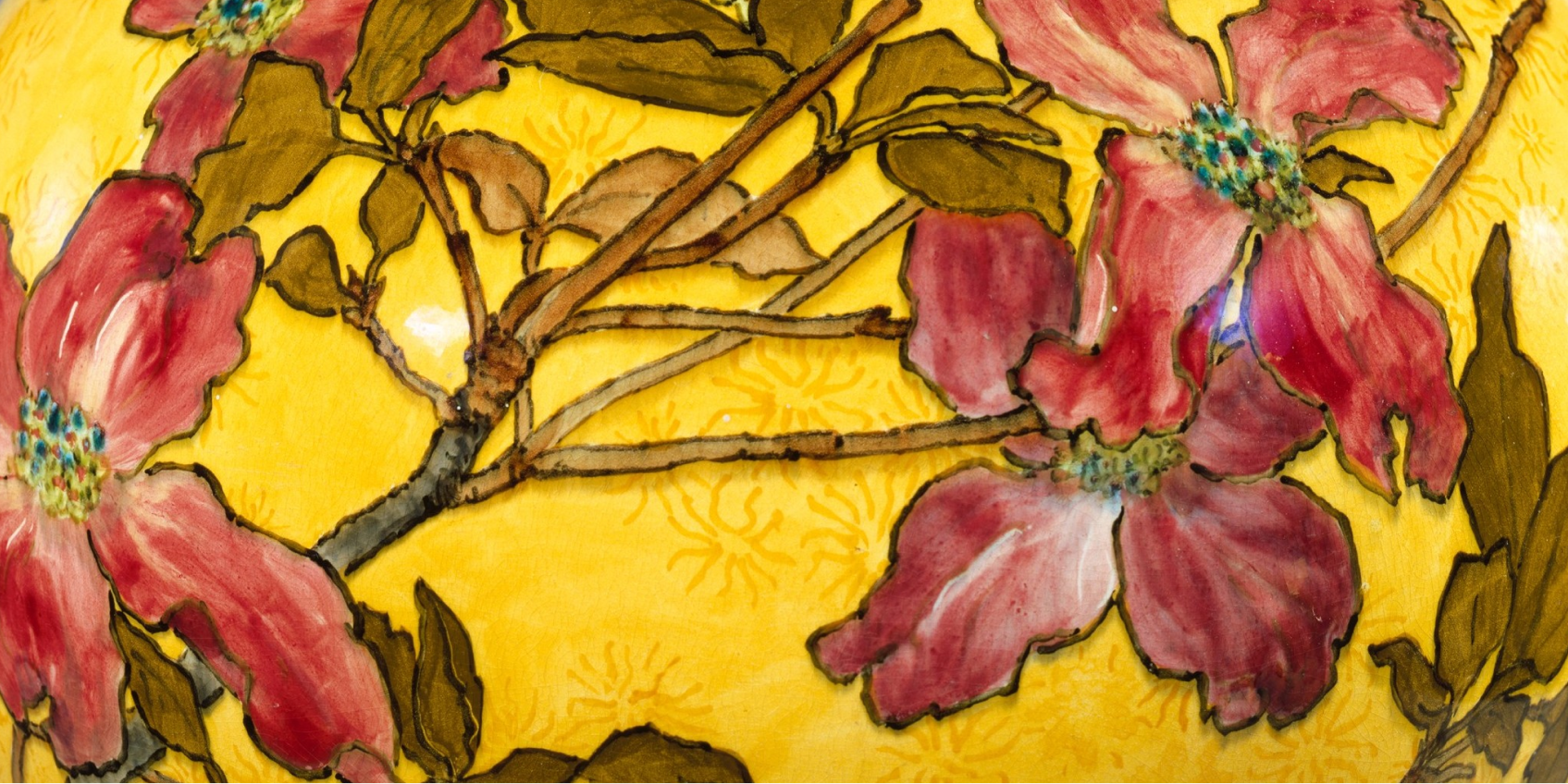 yellow vase with red dogwood blossoms