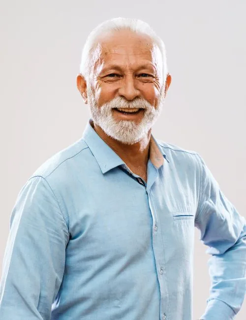 photo of an older man with a white beard wearing a blue shirt