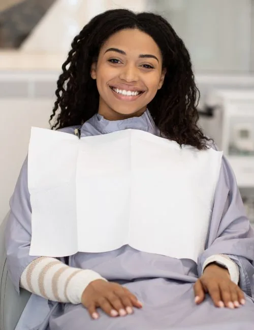 photo of a smiling woman seated in a dental chair