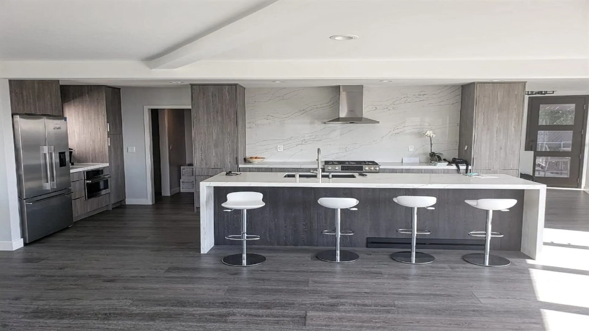 Modern kitchen with wood-grain cabinets and a long island with seating