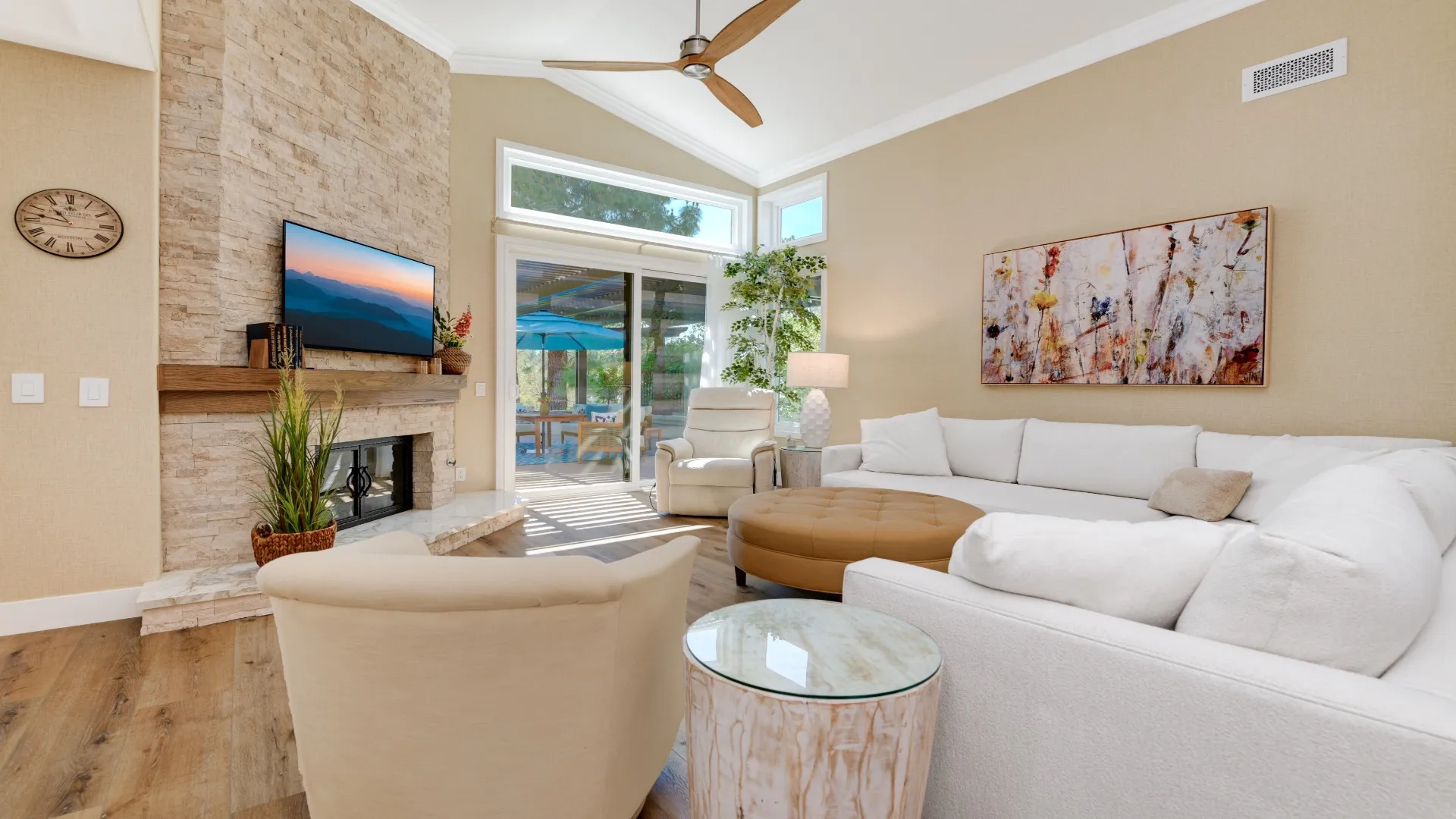 Living room with a stacked-stone fireplace and vaulted ceiling