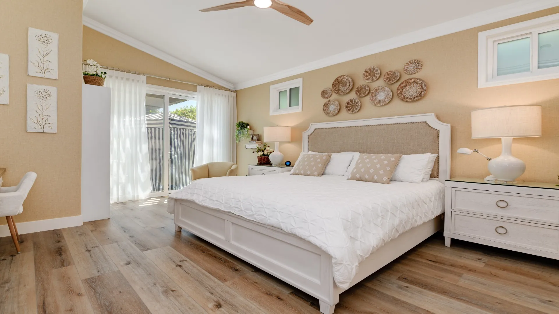 Bedroom with a vaulted ceiling and sliding door to the yard