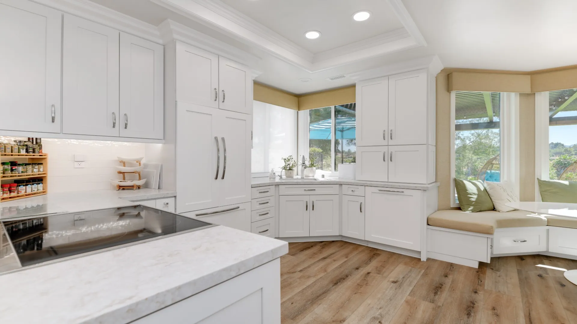 White kitchen with an induction cooktop and window seat