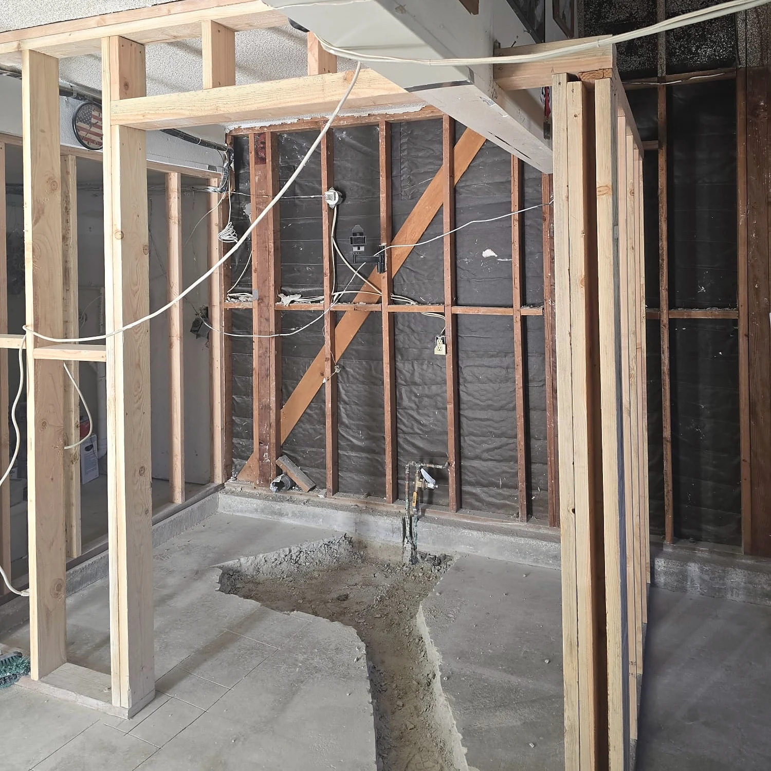 Plumbing trench cut in the garage slab between new framed walls