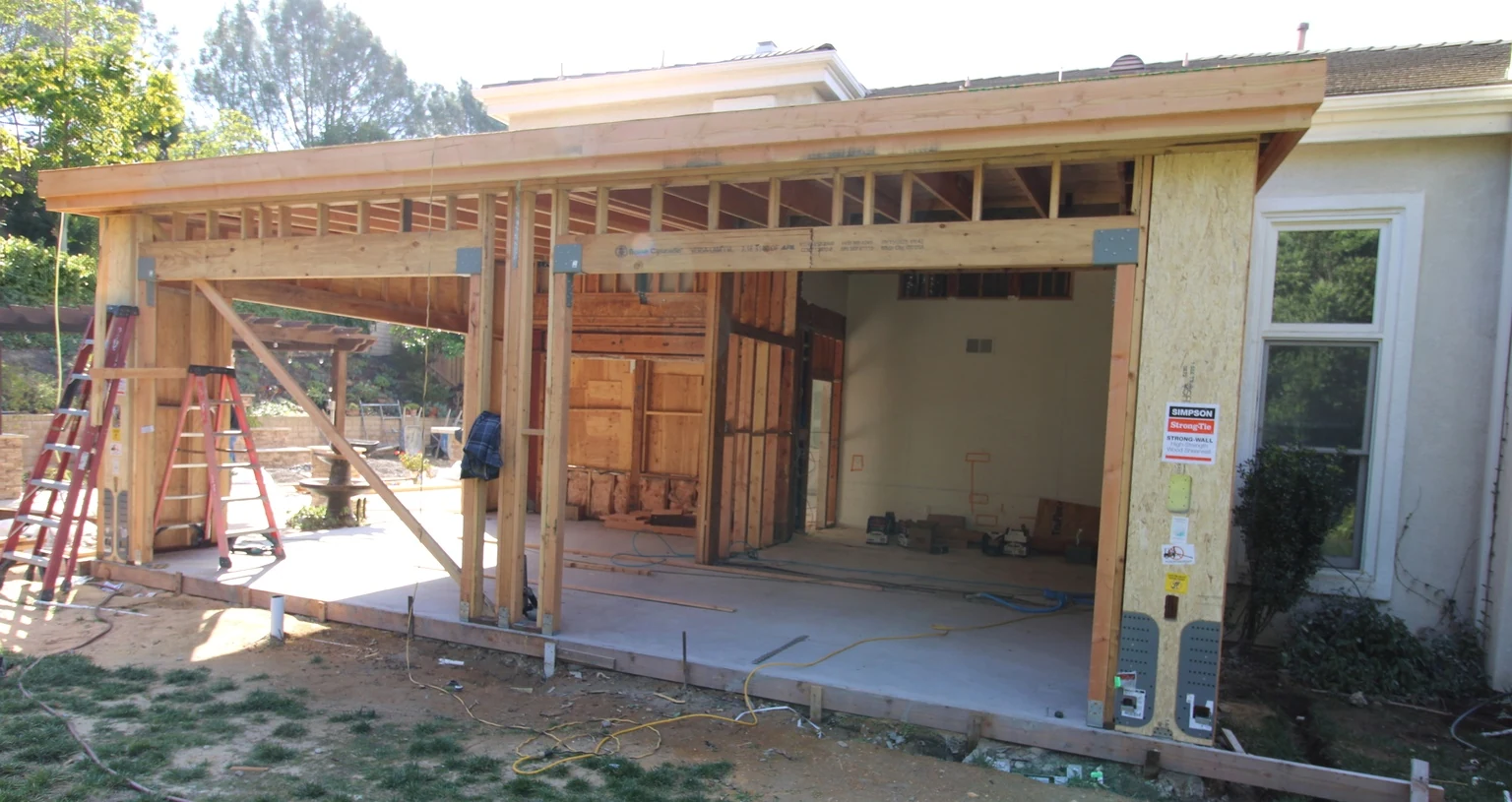 Foundation and framing for a room addition with a new roof