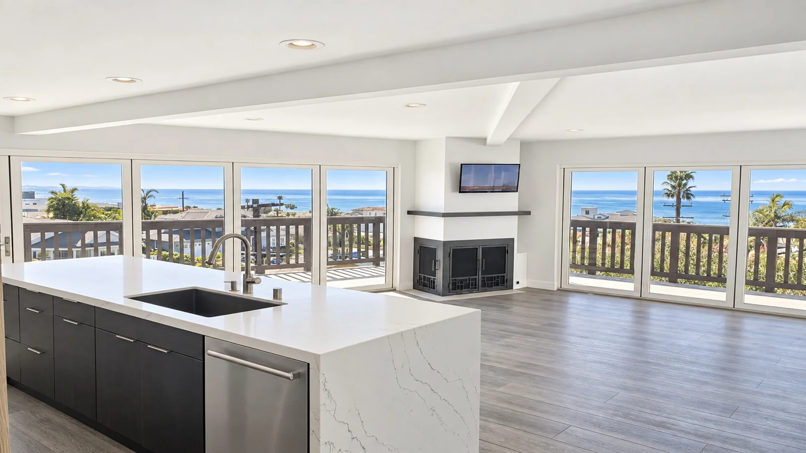 Custom open kitchen with a waterfall island and ocean views