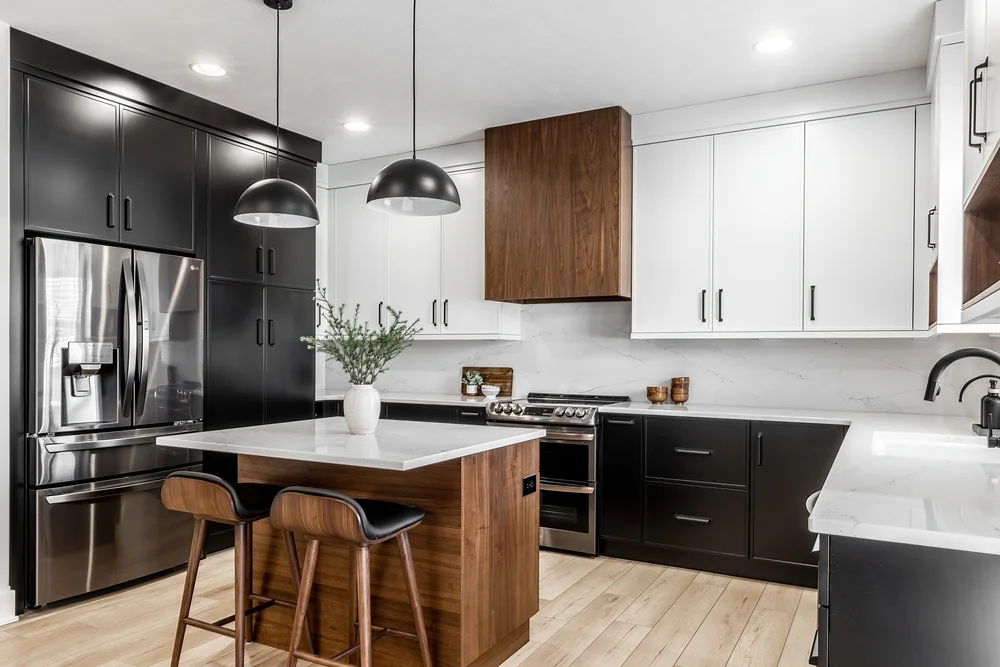 Custom black and white kitchen with a walnut island