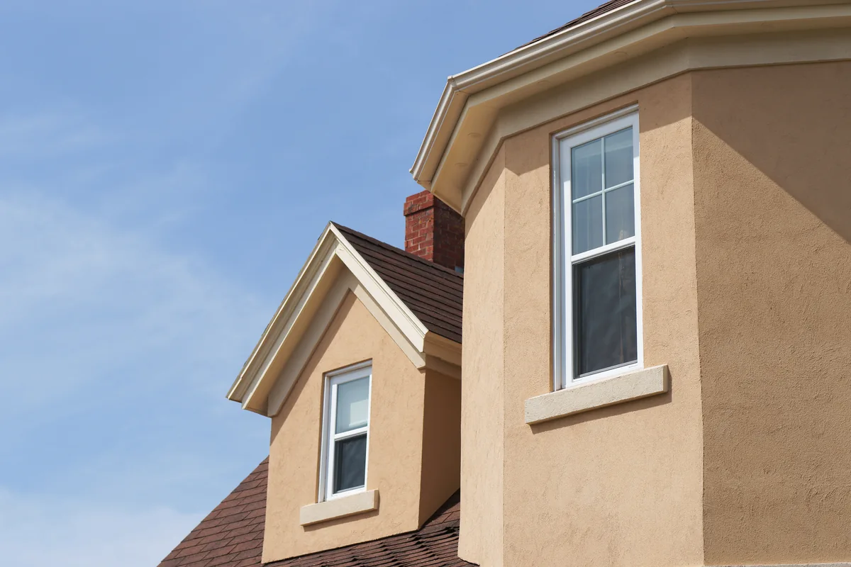 Finished stucco exterior with dormer windows