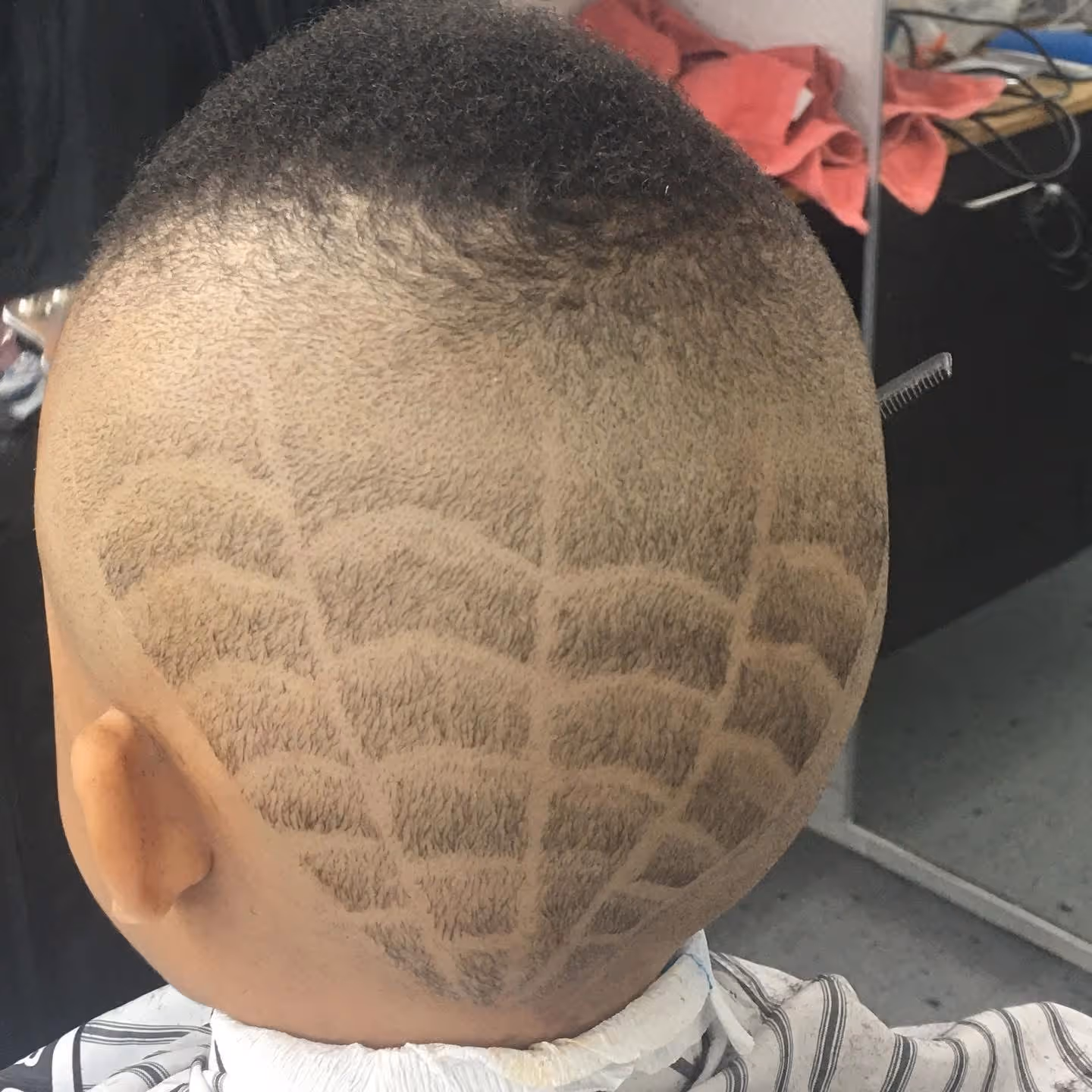 Fade haircut with artwork at Fineboy Barbershop