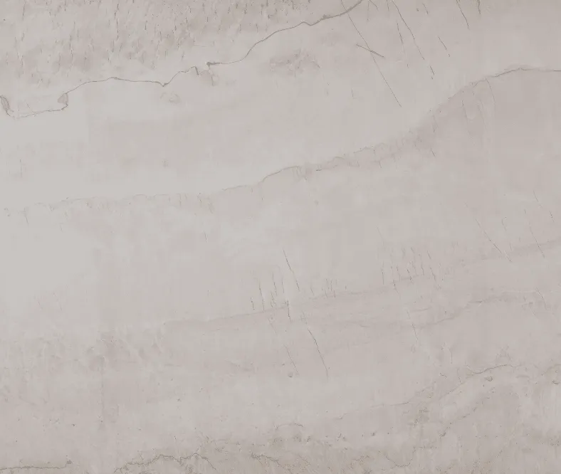 Light gray stone surface with soft, natural horizontal striations, resembling marble or travertine.