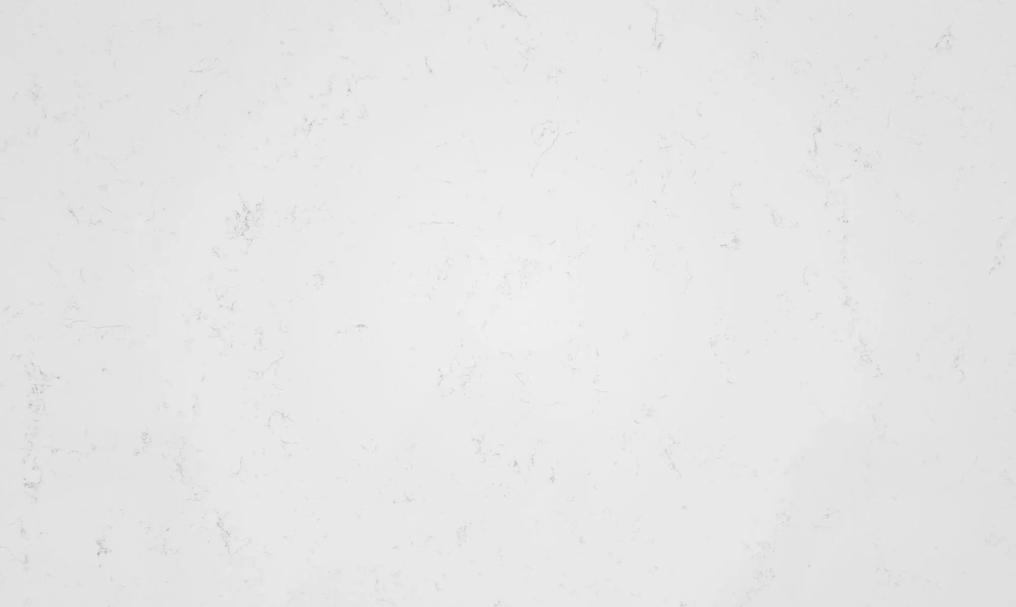 White stone surface with subtle gray veining, resembling quartz or marble.