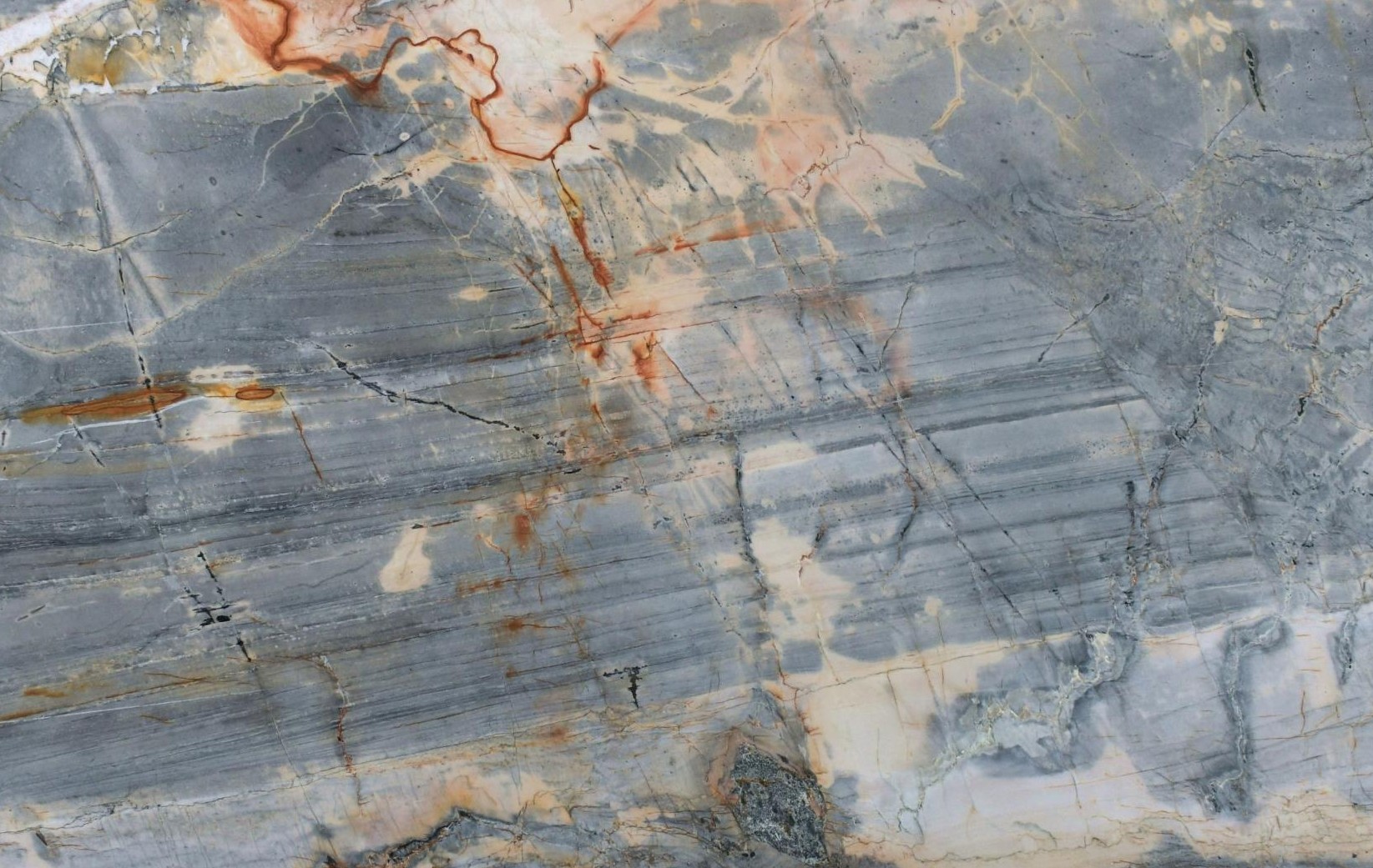 Blue-gray quartzite slab with orange and rust veining