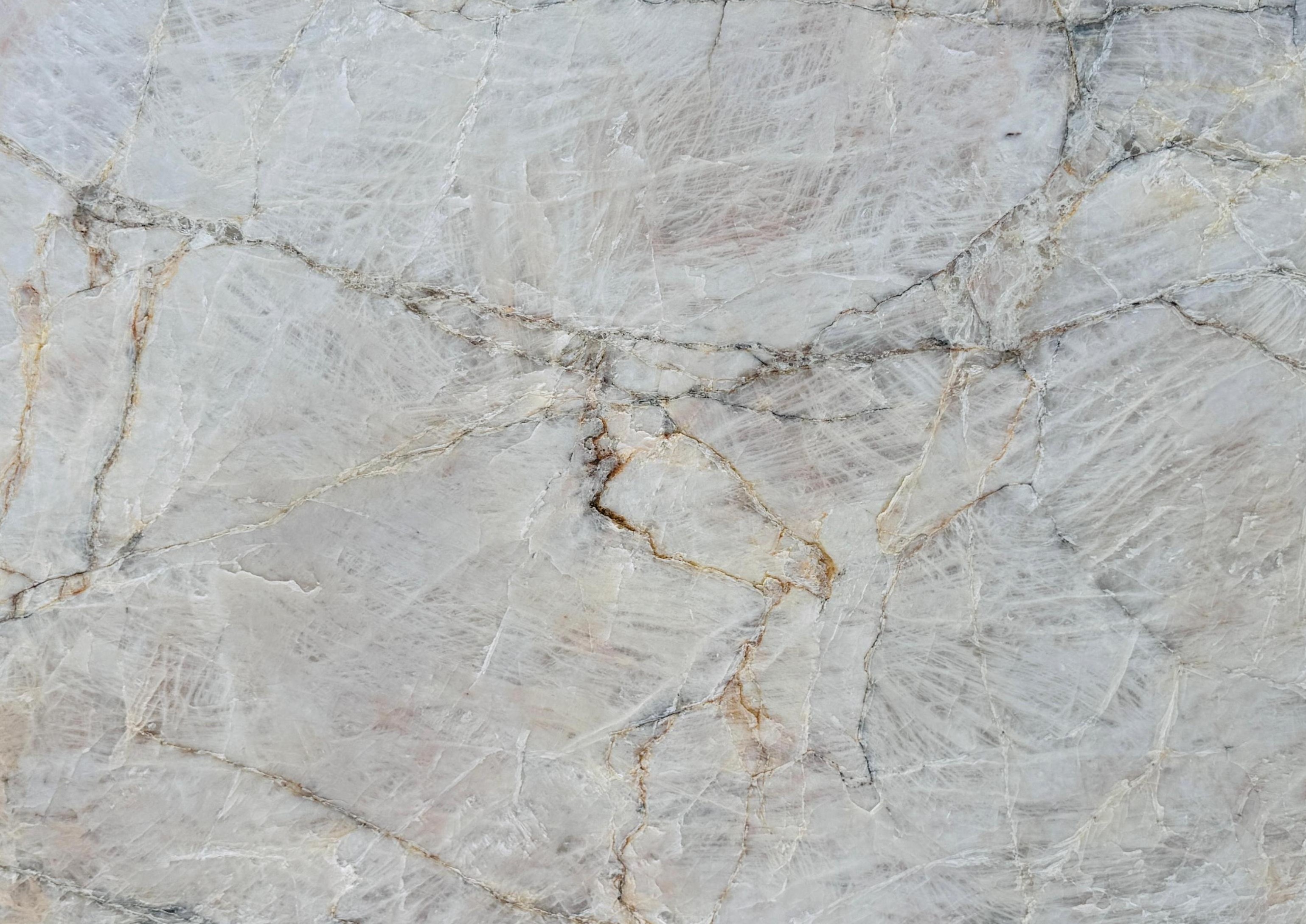 White and gray leathered quartzite slab with natural fissures