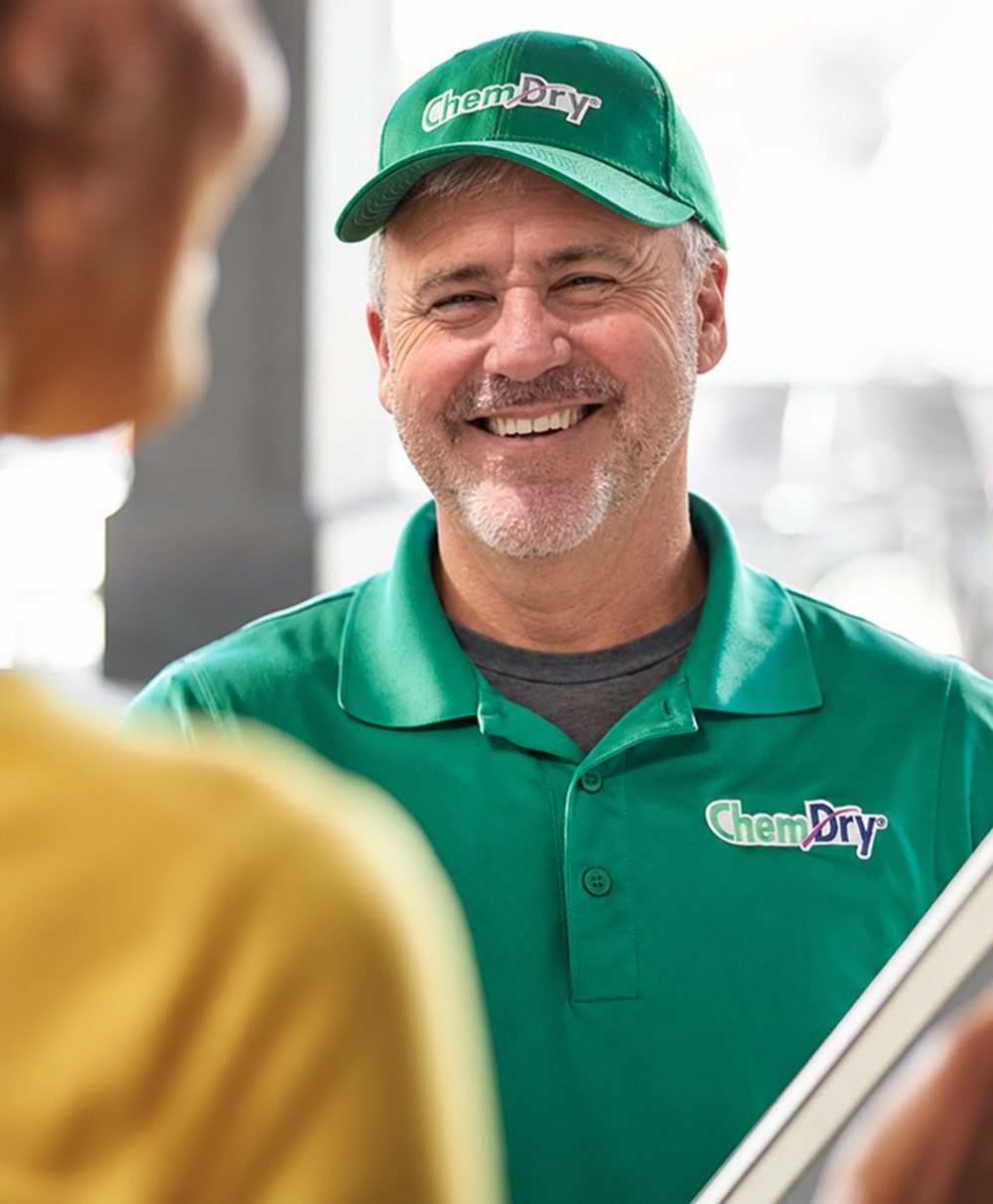 Dr. Chem-Dry technician greeting a customer at the door