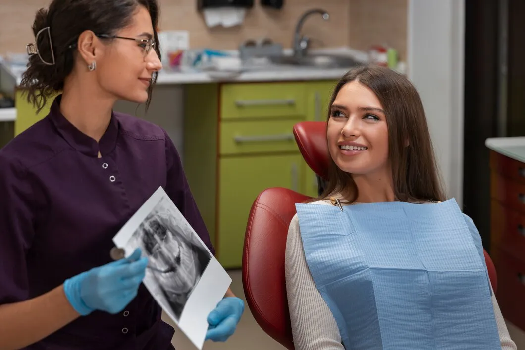Dentist showing a dental X-ray to a patient in the chair