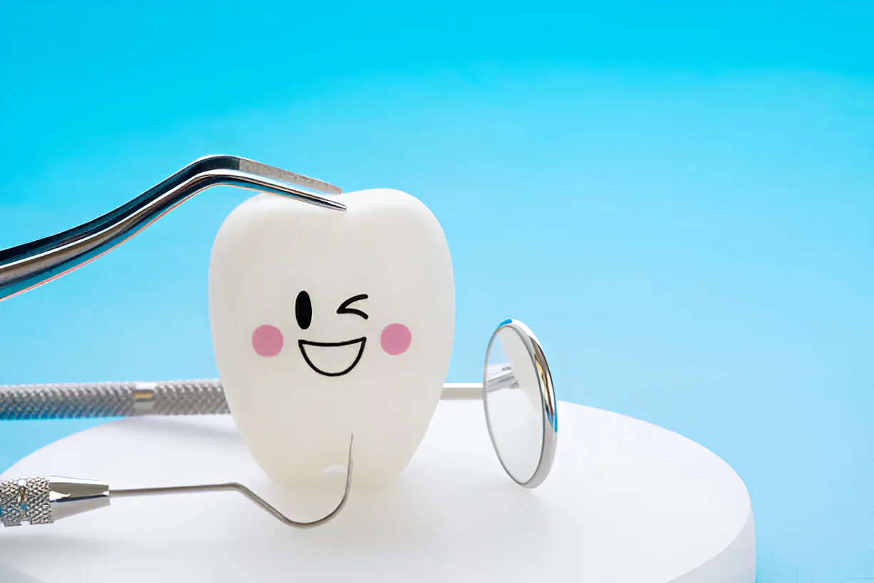Cartoon tooth character winking beside dental instruments