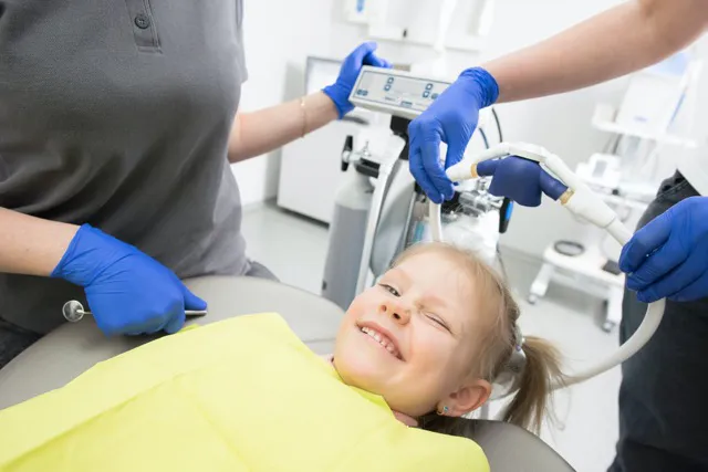 Young child in a dental chair having a dental X-ray taken