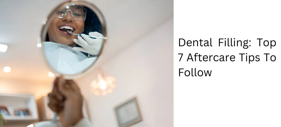 Dental mirror reflecting a smiling patient after a filling
