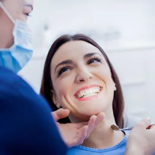 Smiling woman having her teeth checked by a dentist