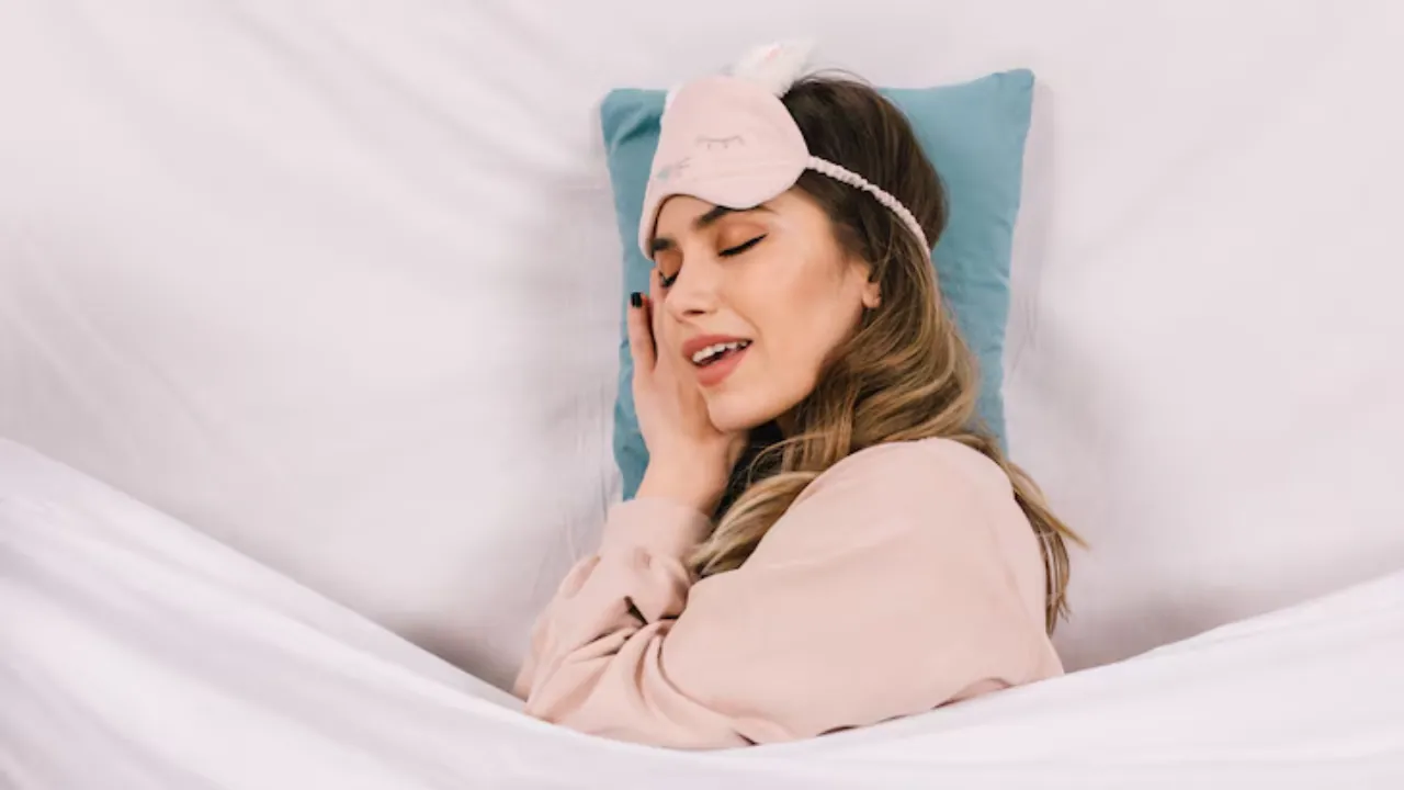 Woman sleeping peacefully wearing a padded sleep mask, resting on a pillow