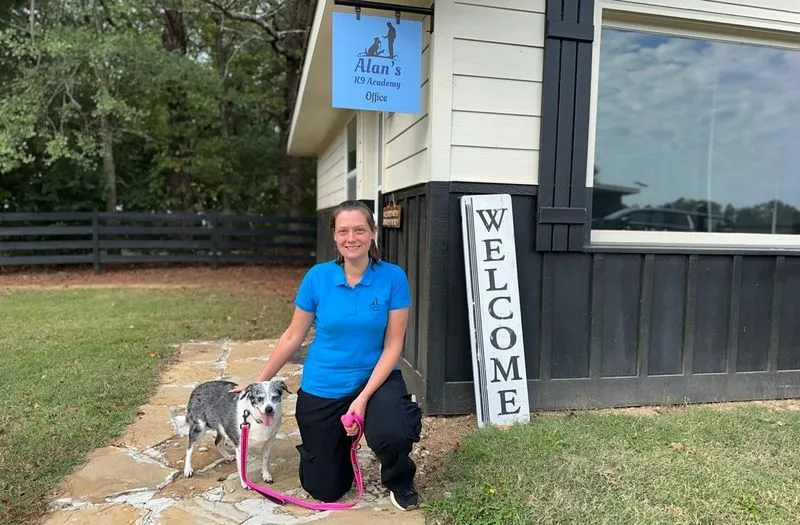 Makayla kneeling next to a dog