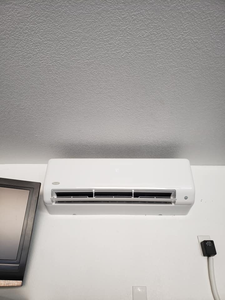 A wall-mounted ductless mini-split air conditioning unit installed indoors.