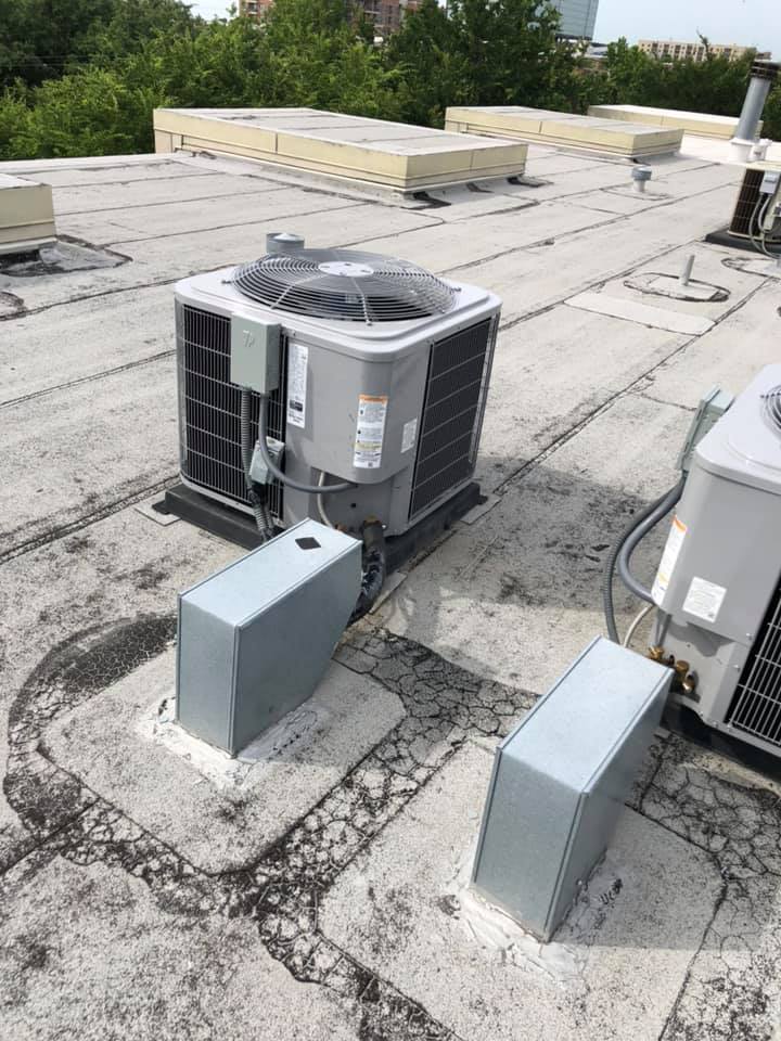 Commercial HVAC units installed on a flat roof in Plano, TX.