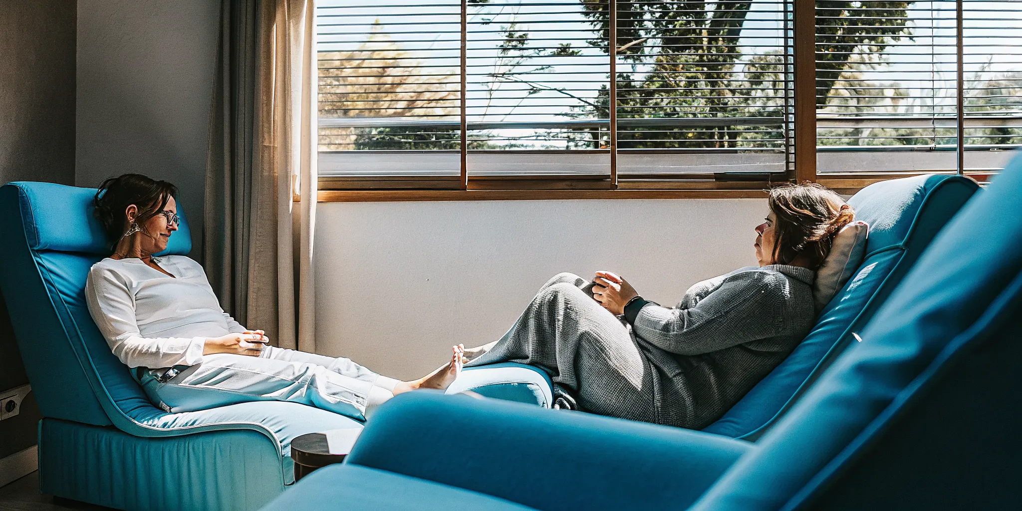 A therapist and patient in a calm, modern therapy office with natural light
