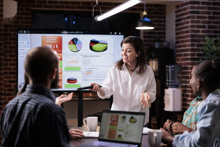 Business team presentation with performance charts and data visualization representing strategy analysis, collaboration and digital growth planning Hiweb