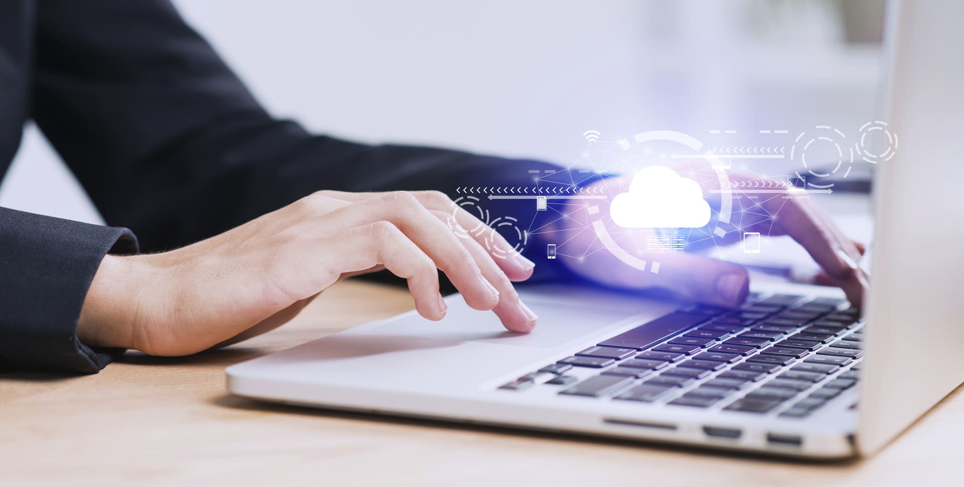 Professional using a laptop with cloud technology interface, representing digital transformation and software solutions Hiweb