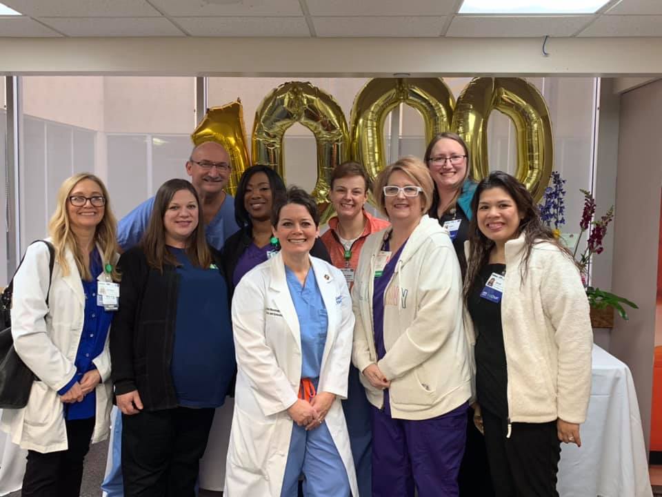 A group of male and female Baptist Health career professionals celebrating 1000 years.