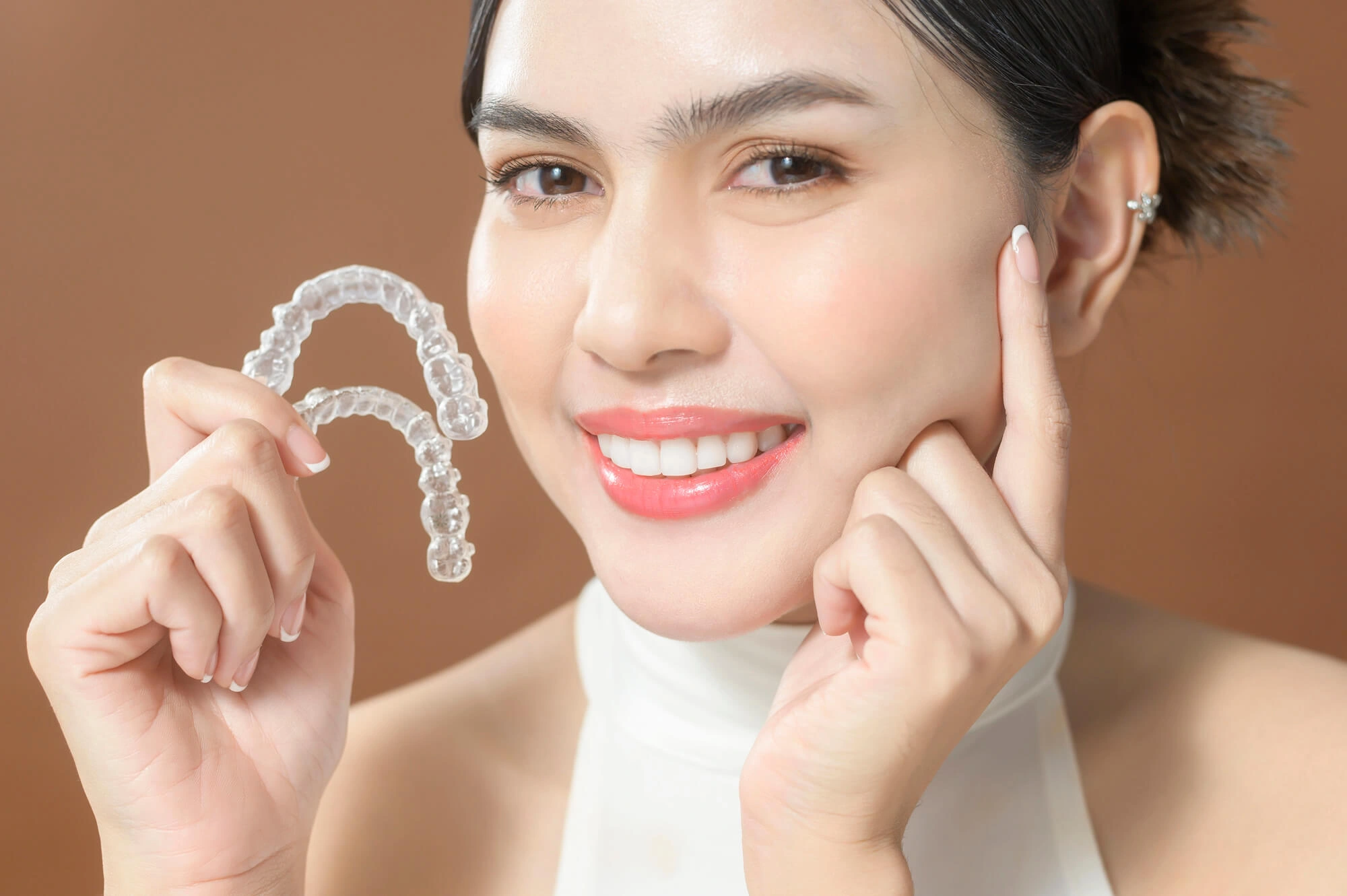 Woman holding invisalign levittown