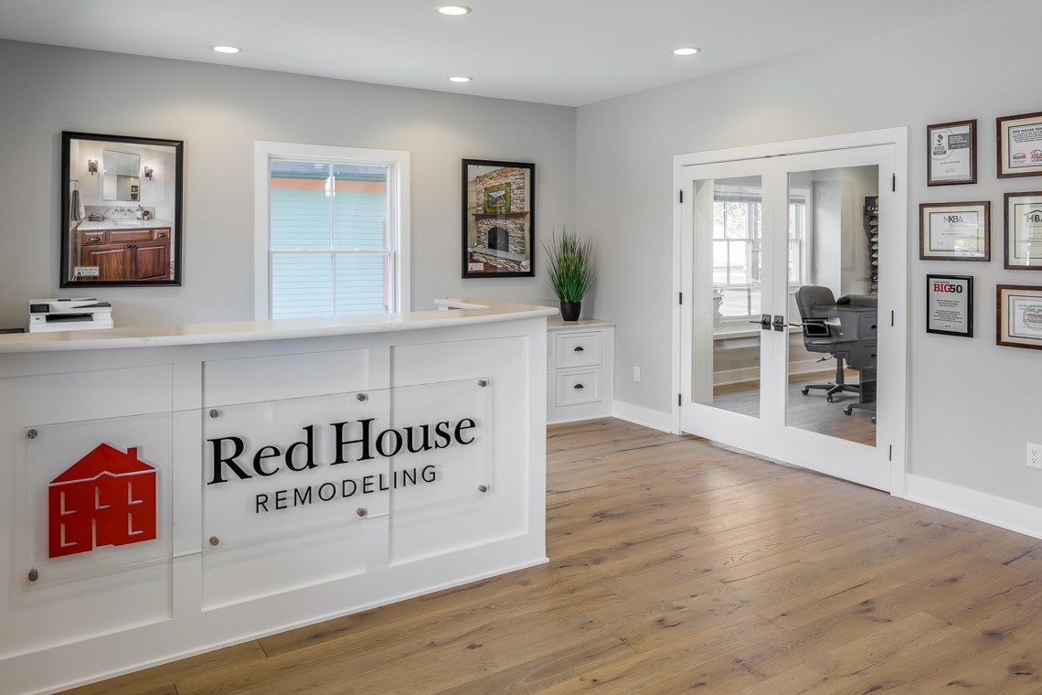 The interior of Red House Remodeling's office. Light gray walls and warm wood flooring.