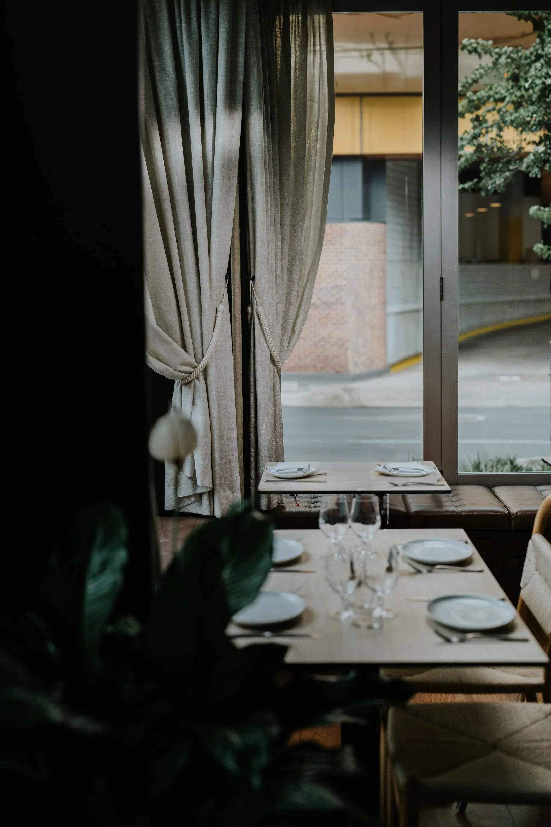 A table at a restaurant with a scenic view through a window.