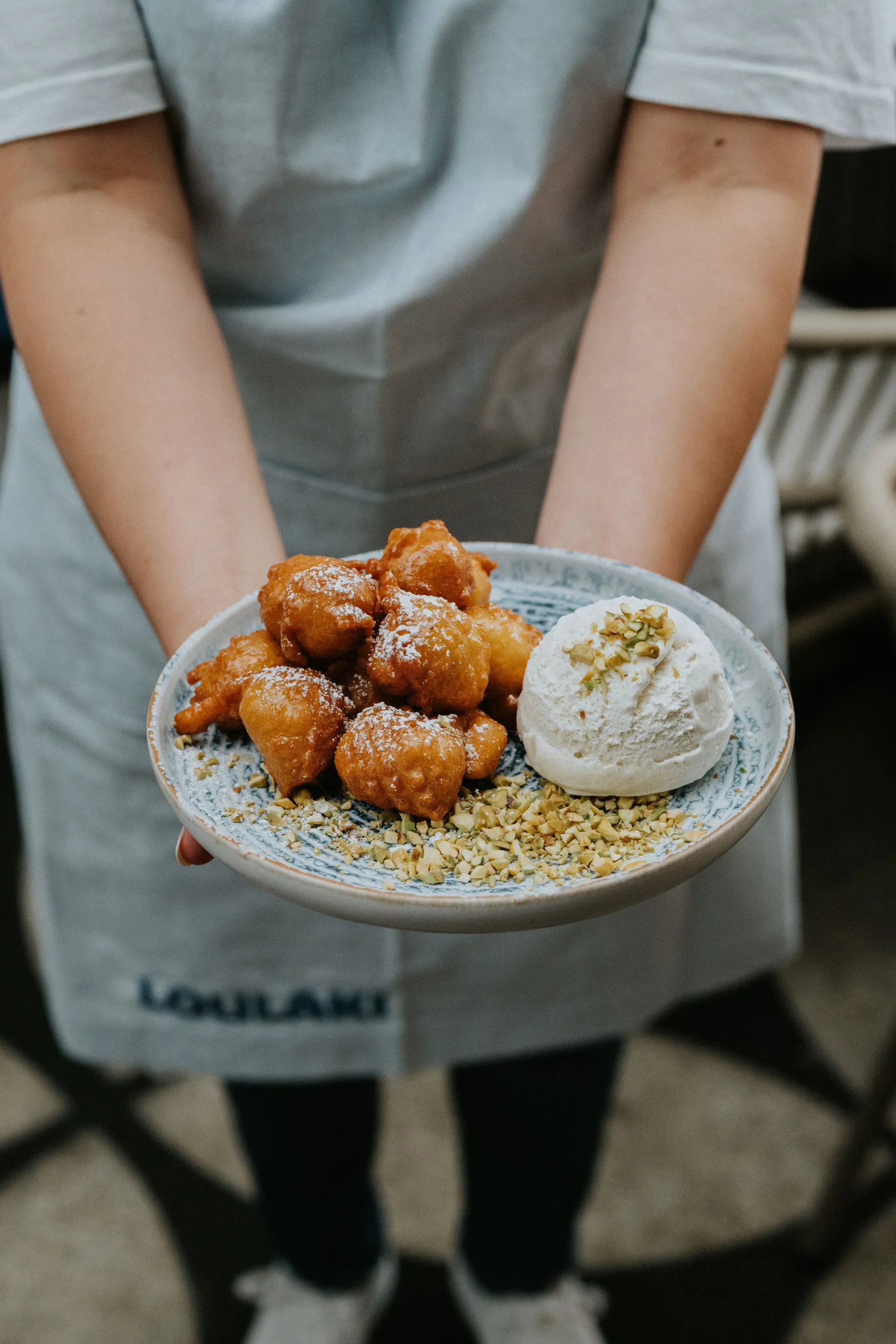 A person holding a plate of food.