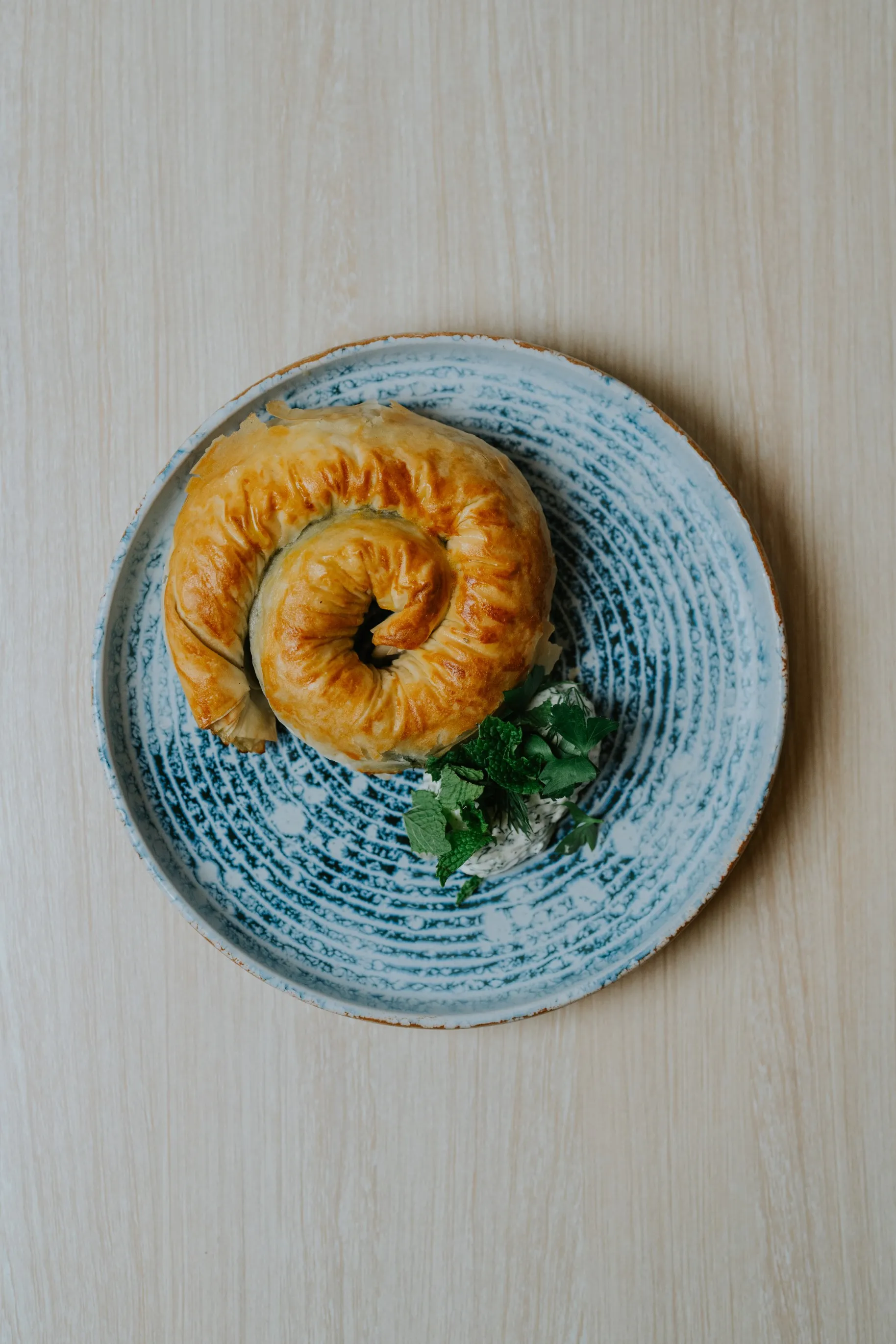 A plate with a delicious pastry on it, tempting with its golden crust and sweet aroma.