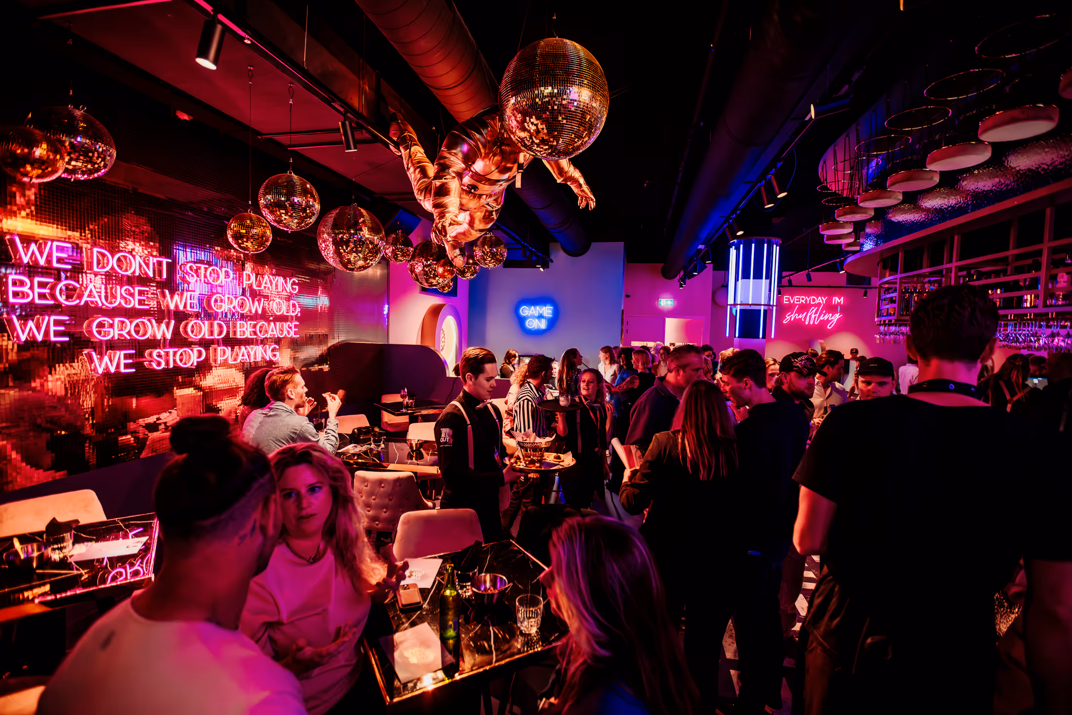 a colorful bar full of people.