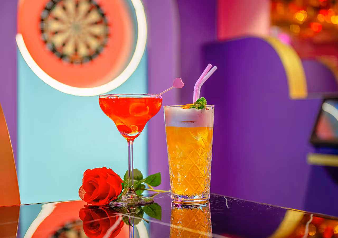 valentines themed cocktails, a rose in front of a dartboard