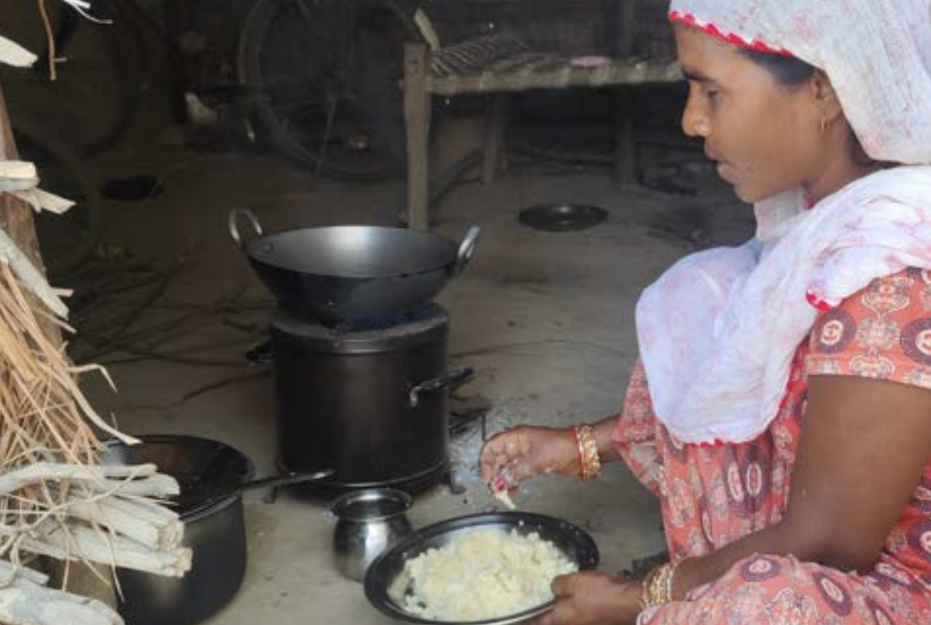 A woman in Nepal's Terai region cooking on an improved near-smokeless cookstove