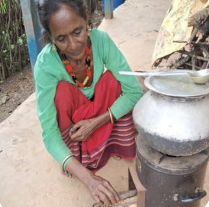 A woman in Nepal's Terai region cooking on an improved near-smokeless cookstove