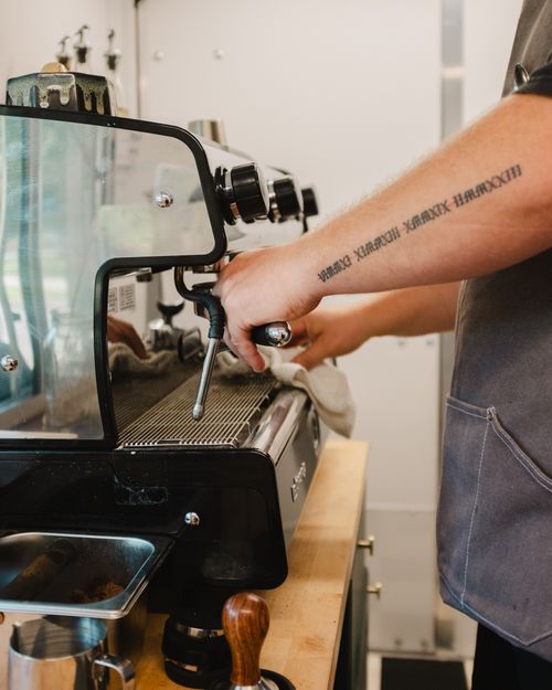 A man is making a cup of coffee
