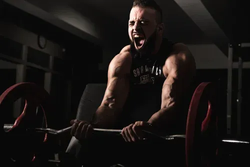 Body builder doing bicep curls in chelsea new york city gym called completebody.
