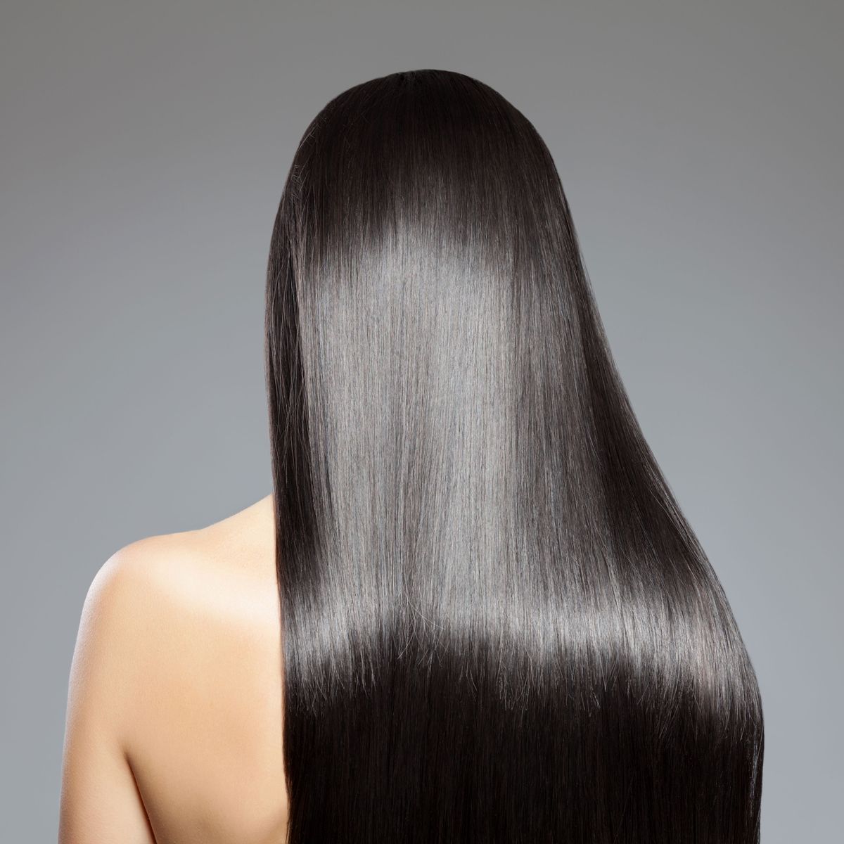 Woman with black hair facing back, keratin 